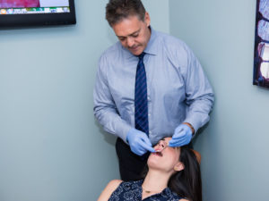 Dr Gordon examines an adult orthodontic patient